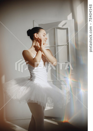 Ballerina posing in front of white background Ballerina posing in front of white background 78404548