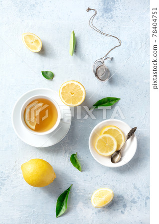 Lemon tea in a cup, overhead flat lay shot on a slate background. Organic lemons Lemon tea in a cup, overhead flat lay shot on a slate background. Organic lemons 78404751