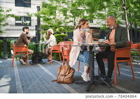 Reunion of woman with senior father outdoors in city, life after covid-19 vaccination and back to normal concept. Reunion of woman with senior father outdoors in city, life after covid-19 vaccination and back to normal concept. 78404864