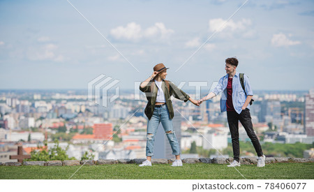 Young couple travelers with map in city on holiday walking and holding hands. Young couple travelers with map in city on holiday walking and holding hands. 78406077