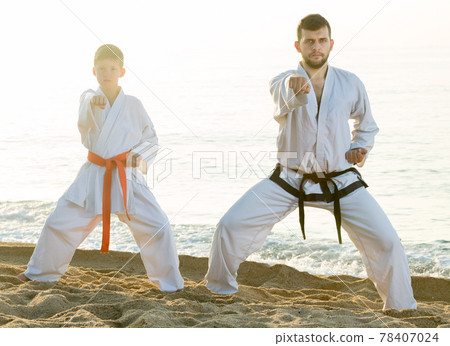 Man and teen boy doing karate 78407024