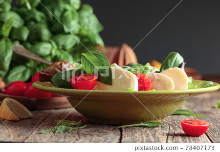 Green salad with mozzarella, tomato and basil. Green salad with mozzarella, tomato and basil. 78407173
