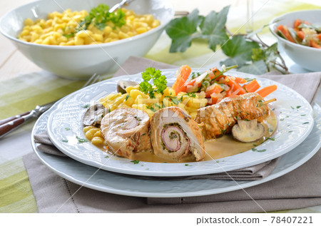 Stuffed turkey rolls with ham and spring onions in mustard sauce,spaetzle and carrots as a side dish Stuffed turkey rolls with ham and spring onions in mustard sauce,spaetzle and carrots as a side dish 78407221
