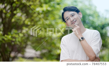 Young man thinking outdoors Young man thinking outdoors 78407553