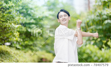 Young man stretching outdoors 78407579