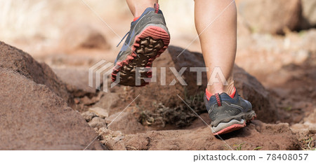 Athlete trail running in the mountains on rocky terrain, sports shoes detail 78408057