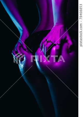 Big sexy ass of girl with slim figure with neon light. Woman's body in drops water and sweat 78408853