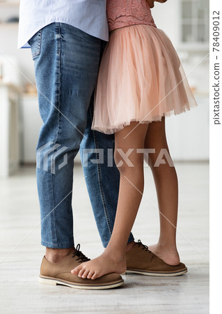 Legs of father and daughter having dance lesson at home 78409012