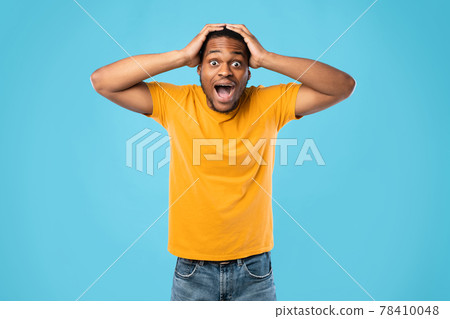 Shocked African American Guy Shouting Touching Head Over Blue Background Shocked African American Guy Shouting Touching Head Over Blue Background 78410048