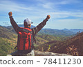 Young asian man tourist with backpack relaxing on top rock and enjoying sunset. Lifestyle Travel happy emotions success concept summer vacations outdoor. Hiker tramping up famous trail.. 78411230