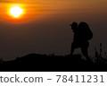 Travel young asian man tourist alone on the edge cliff mountains and looking on the valley. Silhouette of the person on the high rock at sunset. Hiking adventure lifestyle extreme vacations. 78411231