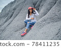 Young asian woman sit on the snow mountain at the Grand Canyon Chonburi at the Khiri Nakhon Stone Mine near the city of Chonburi in the Province Chonburi in Thailand. 78411235