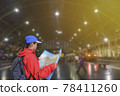 Young asian woman reading map while standing at railroad station platform. women backpacker is waiting for a train in Bangkok Rail station. Hua Lamphong Rail Station, Thailand. 78411260