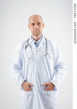 Serious physician looking at camera Serious physician looking at camera 78411494