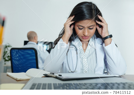 Stressed young general practitioner Stressed young general practitioner 78411512