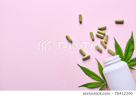 Cannabis extract capsules and hemp leaves on pink background. Calming, anti-stress and sleeping concept 78412200