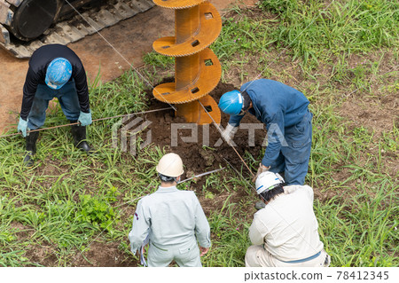 Construction site foundation work, auger screw advance excavation, position confirmation Construction site foundation work, auger screw advance excavation, position confirmation 78412345