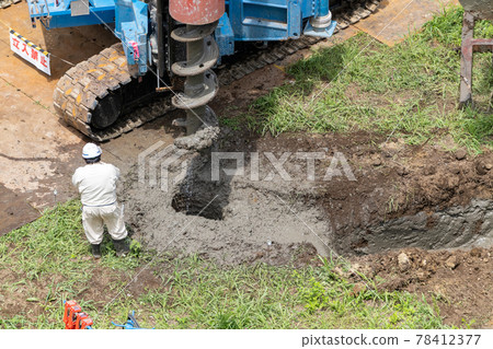 Construction site foundation work, auger screw pull-out, excavation hole 78412377