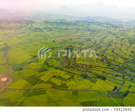 Aerial Panorama of Semien mountains and valley with fields of teff around Lalibela, Ethiopia 78413645