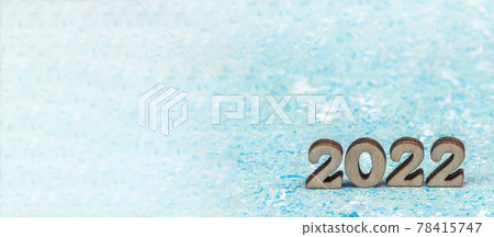 Numerals 2022 on blue background. Wooden digits 2022. Numerals 2022 on blue background. Wooden digits 2022. 78415747