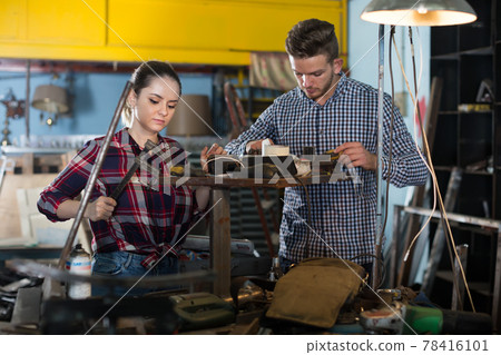 two workers are standing on workplace two workers are standing on workplace 78416101