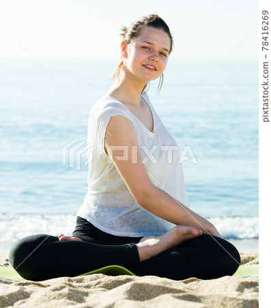 Portrait of sportswoman which is practicing stretching in white T-shirt Portrait of sportswoman which is practicing stretching in white T-shirt 78416269