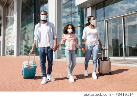 Happy black family traveling with kid, walking out airport Happy black family traveling with kid, walking out airport 78419114