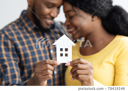 African American Spouses Holding Cutout Paper House Figure In Hands African American Spouses Holding Cutout Paper House Figure In Hands 78419146