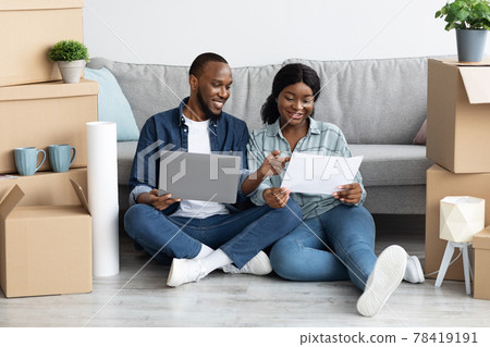 Black Couple With Blueprints And Laptop Planning Interior Design In New Flat 78419191