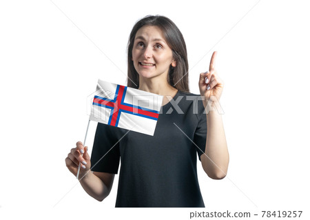 Happy young white woman holding flag of Faroe Islands and points thumbs up isolated on a white background Happy young white woman holding flag of Faroe Islands and points thumbs up isolated on a white background 78419257