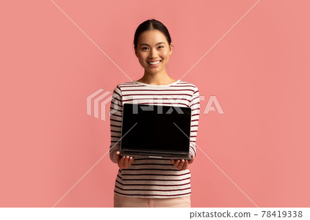 Smiling Korean Lady Demonstrating Laptop With Blank Black Screen In Her Hands 78419338