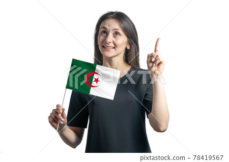 Happy young white woman holding flag of Algeria and points thumbs up isolated on a white background Happy young white woman holding flag of Algeria and points thumbs up isolated on a white background 78419567