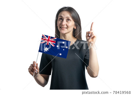 Happy young white woman holding flag of Australia and points thumbs up isolated on a white background Happy young white woman holding flag of Australia and points thumbs up isolated on a white background 78419568