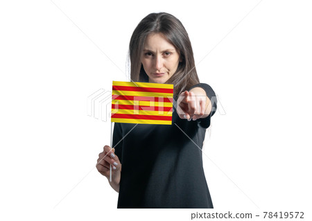 Happy young white woman holding flag of Catalonia and points forward in front of him isolated on a white background Happy young white woman holding flag of Catalonia and points forward in front of him isolated on a white background 78419572