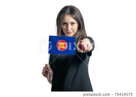 Happy young white woman holding flag of Association of Southeast Asian Nations and points forward in front of him isolated on a white background Happy young white woman holding flag of Association of Southeast Asian Nations and points forward in front of him isolated on a white background 78419575
