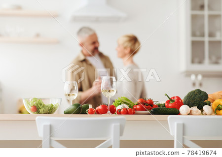 Happy loving couple, romantic dance on date in modern kitchen, smiling husband and wife celebrate anniversary Happy loving couple, romantic dance on date in modern kitchen, smiling husband and wife celebrate anniversary 78419674