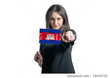 Happy young white woman holding flag of Cambodia and points forward in front of him isolated on a white background 78419730