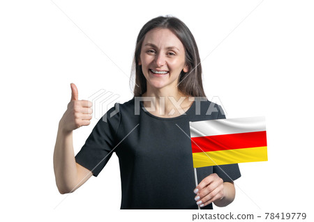 Happy young white woman holding flag of South Ossetia and shows the class by hand isolated on a white background Happy young white woman holding flag of South Ossetia and shows the class by hand isolated on a white background 78419779