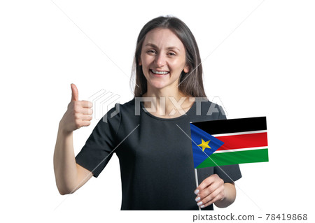Happy young white woman holding flag of South Sudan and shows the class by hand isolated on a white background 78419868