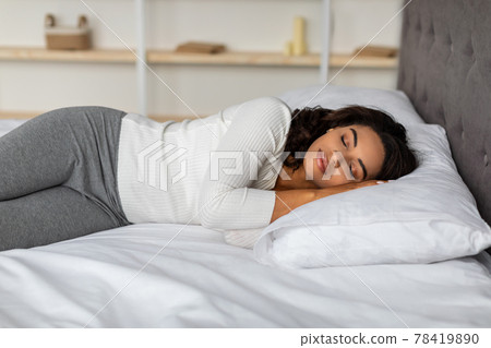Young African American female sleeping in bed 78419890