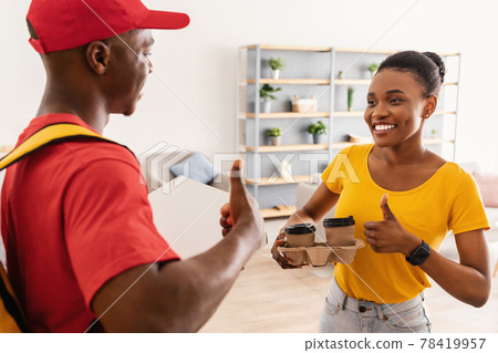 African Delivery Guy And Happy Female Customer Gesturing Thumbs-Up Indoor 78419957