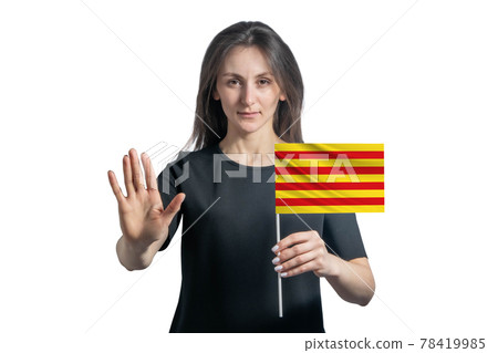 Happy young white woman holding flag of Catalonia and with a serious face shows a hand stop sign isolated on a white background Happy young white woman holding flag of Catalonia and with a serious face shows a hand stop sign isolated on a white background 78419985