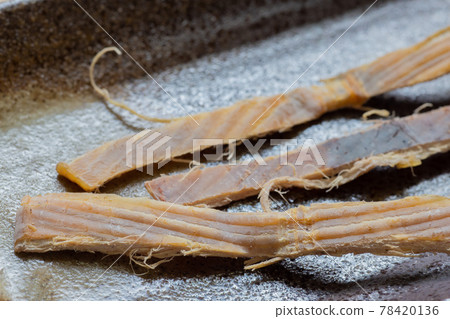 Squid dried squid on a plate 78420136