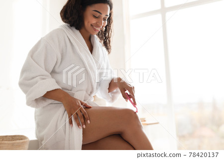 Pretty African Young Woman Making Depilation Shaving Legs In Bathroom Pretty African Young Woman Making Depilation Shaving Legs In Bathroom 78420137
