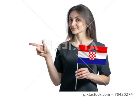 Happy young white woman holding flag Croatia and points to the left isolated on a white background Happy young white woman holding flag Croatia and points to the left isolated on a white background 78420274