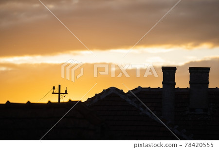 Suburban scene with sunset and dramatic sky 78420555