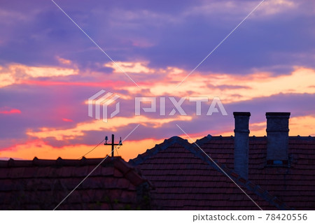 Suburban scene with sunset and dramatic sky 78420556