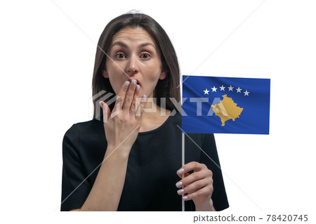 Happy young white woman holding flag of Kosovo and covers her mouth with her hand isolated on a white background 78420745