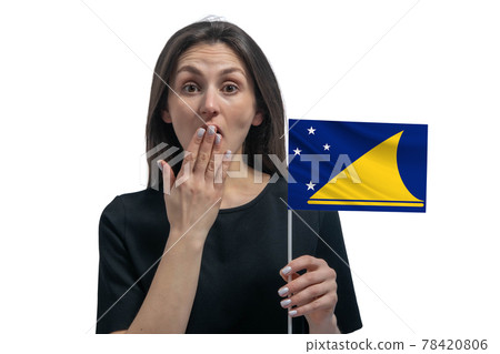 Happy young white woman holding flag of Tokelau and covers her mouth with her hand isolated on a white background Happy young white woman holding flag of Tokelau and covers her mouth with her hand isolated on a white background 78420806