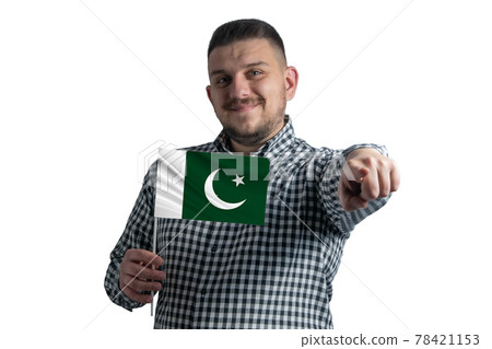White guy holding a flag of Pakistan and points forward in front of him isolated on a white background White guy holding a flag of Pakistan and points forward in front of him isolated on a white background 78421153